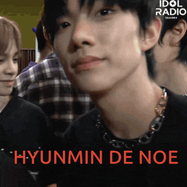 a close up of hyunmin de noe 's face with the word idol radio behind him