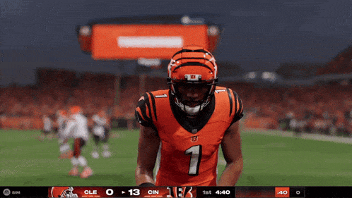 a football player wearing a number 1 jersey stands on a field