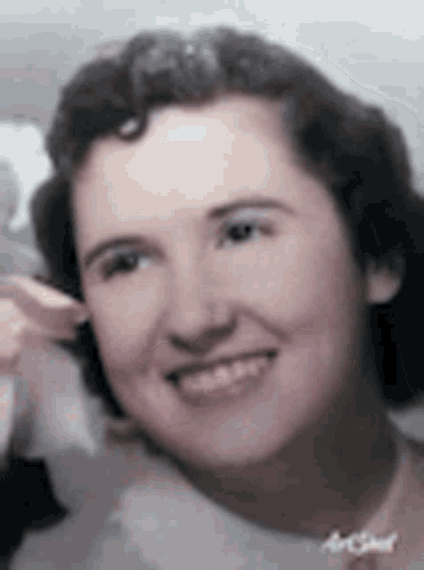 a close up of a woman 's face with a smile on her face .