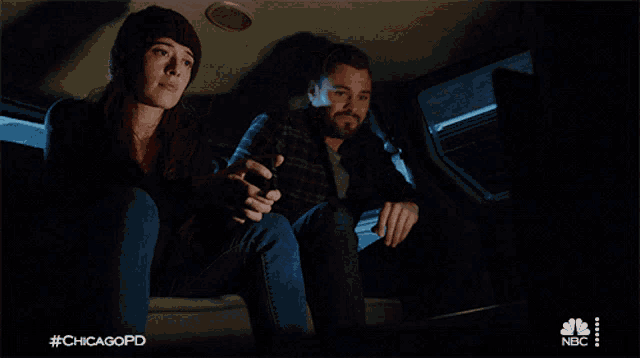 a man and a woman are sitting in the back of a car with #chicagopd