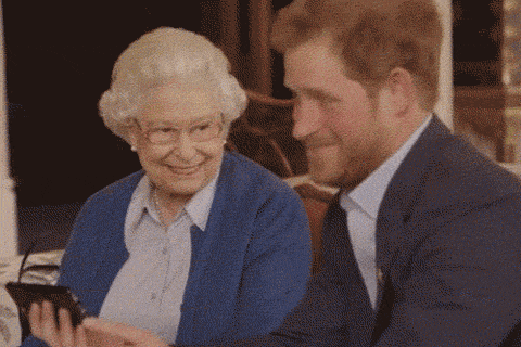 a man in a suit is sitting next to an elderly woman in a blue sweater