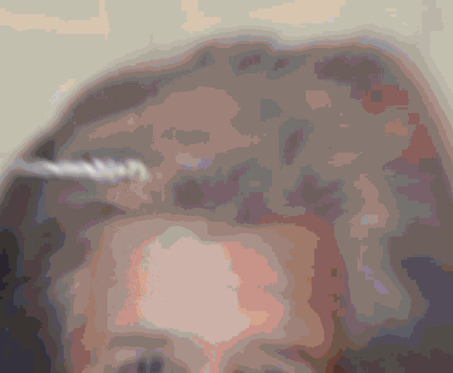 a blurry picture of a person 's head with a few spots of light on it
