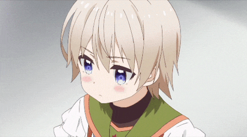 a little girl with white hair and blue eyes is wearing a green sweater