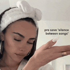 a woman wearing a white headband with the words pre save silence between songs on the bottom