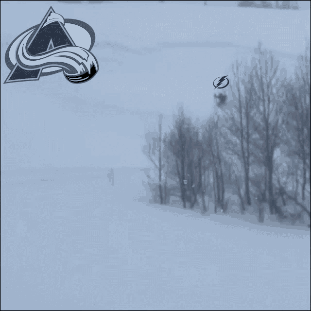 a logo for the colorado avalanche is shown on a snowy field