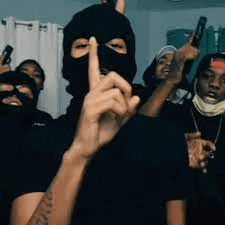 a group of people wearing masks and holding guns are standing next to each other .