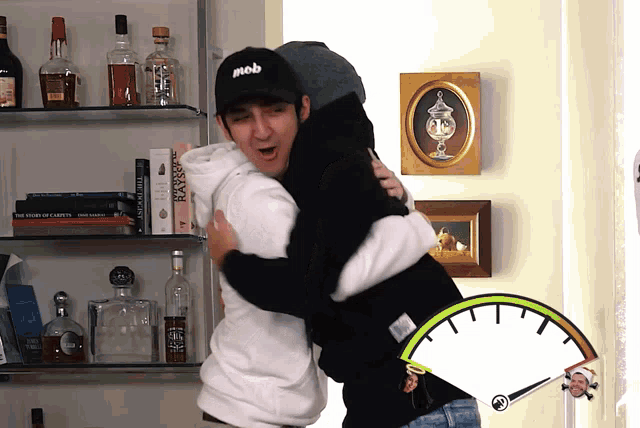 a man in a mob hat hugging another man