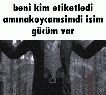 a man in a suit has his arms outstretched in front of a sign that says beni kim etiketledi aminakoycamsimdi isim