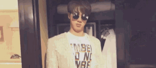 a young man wearing sunglasses and a t-shirt that says made in nc vibe