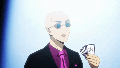 a bald man in a suit and tie is holding a deck of cards