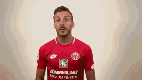 a man wearing a red kommerling premium fenster shirt