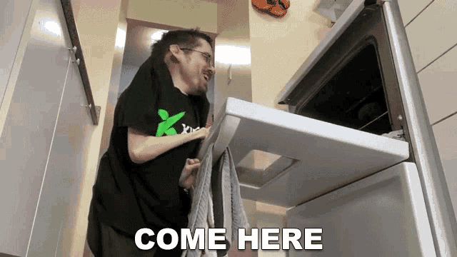 a man is standing in front of an oven with the words come here written on the bottom