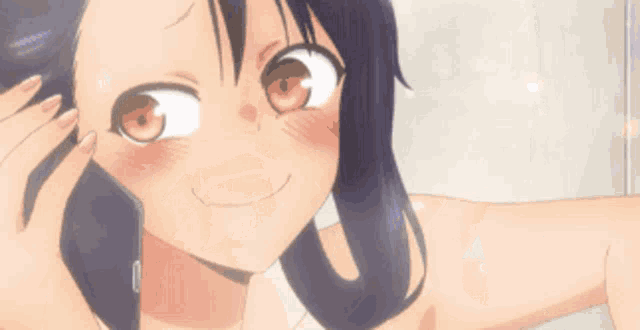 a girl with a phone in her hand looks at herself in the mirror