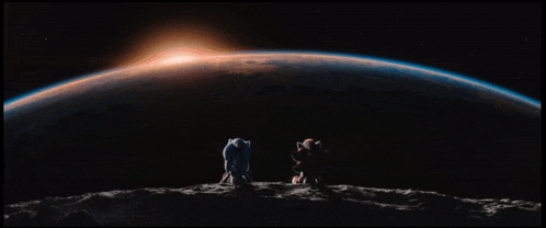 a couple of people looking at the earth in space