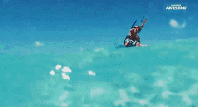 a man is doing a trick on a surfboard in the ocean and the words awesome are on the bottom of the screen