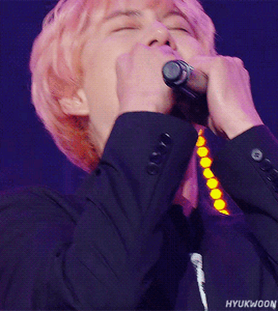 a close up of a person with pink hair and the name hyukwon