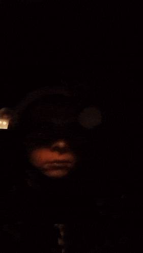 a man wearing glasses and a santa hat has a ball on his head