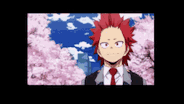 a man with red hair is standing in front of a cherry blossom tree