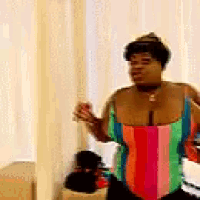a woman is standing in front of a mirror wearing a colorful striped swimsuit