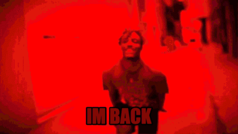 a blurry picture of a man with the words im back on the bottom right