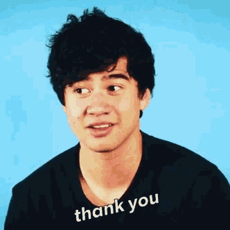 a man wearing a black shirt that says thank you