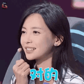 a close up of a woman 's face with a microphone in her hand .