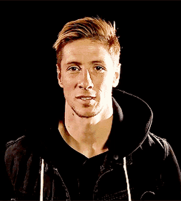 a man with his eyes closed wearing a black sweatshirt