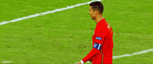 two soccer players shaking hands on the field