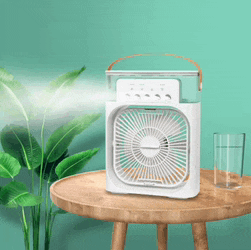 a white fan is sitting on a wooden table next to a glass of water .