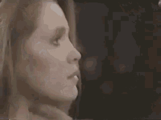 a man and woman are kissing in a blurry photo .