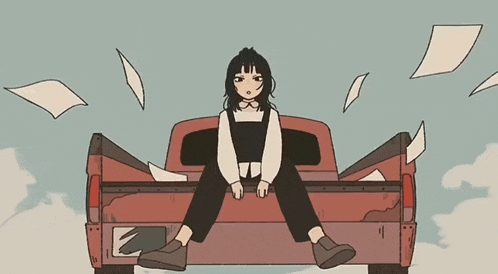 a girl is sitting in the back of a truck with papers flying around her