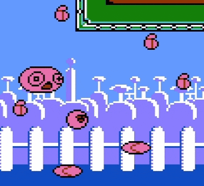 a pixel art drawing of a fence with pink balls flying around