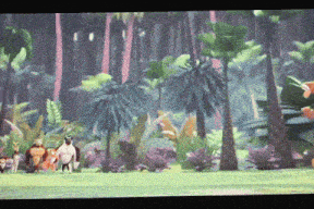 a group of animals are standing in a jungle with palm trees