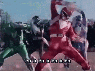 a group of power rangers are standing next to each other in a field and fighting each other .