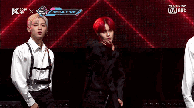a man with red hair is standing in front of a screen that says ' we are k pop '