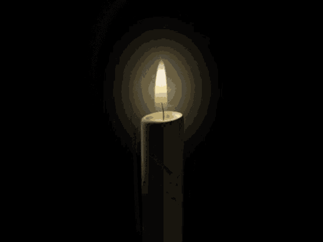 a white candle with a picture of a man on it