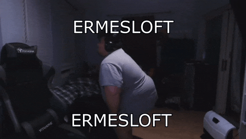 a man wearing headphones stands in front of a chair that says ermesloft on it