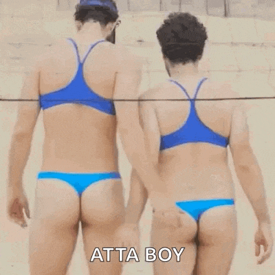 two women in bikinis are holding hands on a beach .