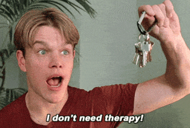a man in a red shirt is holding a bunch of keys and says i don t need therapy