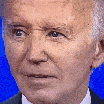 a close up of a man 's face on a blue screen