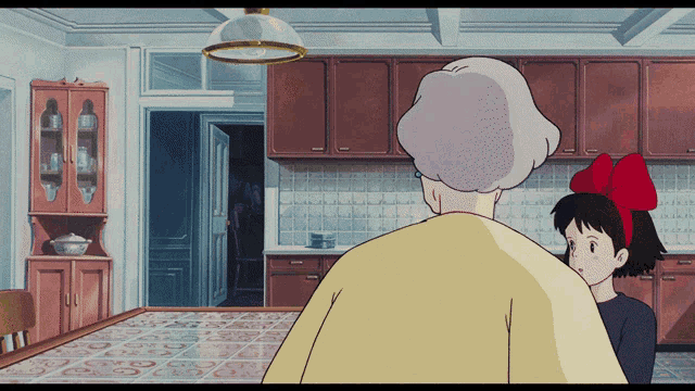 a girl with a red bow is standing next to an older woman