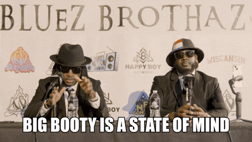 two men sitting in front of microphones with the words big booty is a state of mind written below them