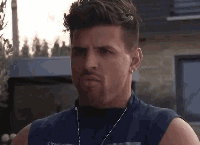 a man wearing a sleeveless shirt with the word texas on the front