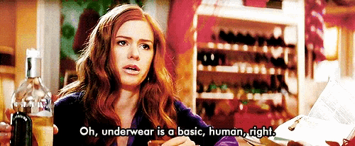 a woman says underwear is a basic human right while holding a bottle of wine