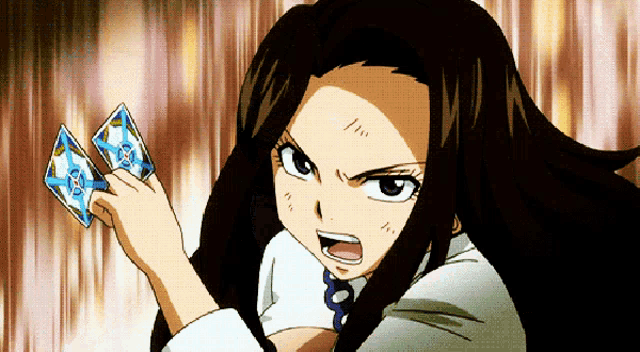 a girl in a white shirt is holding a card that says ' fairy tail '