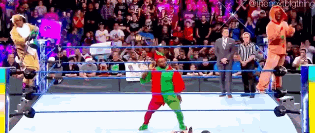 a wrestler in a clown costume is standing in a wrestling ring in front of a crowd .