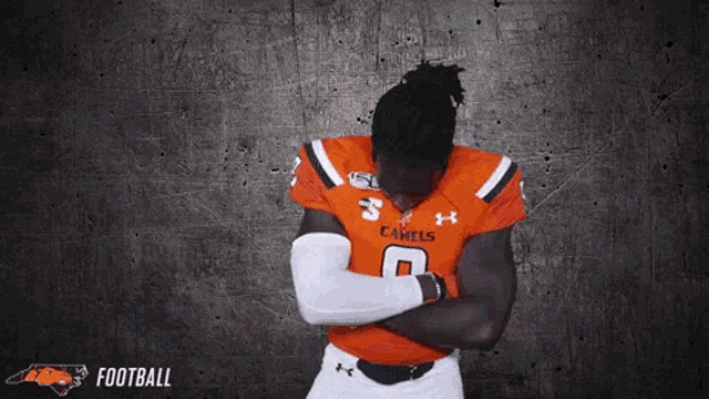 a man in an orange jersey with the number 8 on it