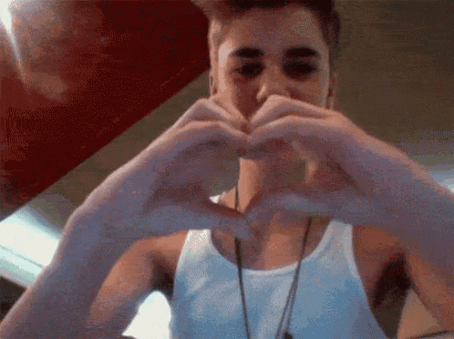 a man making a heart shape with his hands