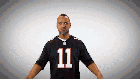 a man wearing a black jersey with the number 11