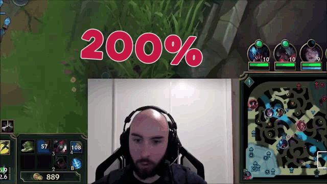 a bald man wearing headphones sits in front of a screen that says ' 200 % ' on it